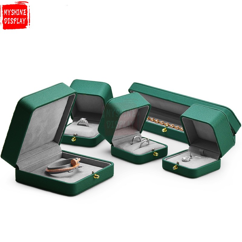 Emerald green leather jewelry packaging box with gray microfiber inside