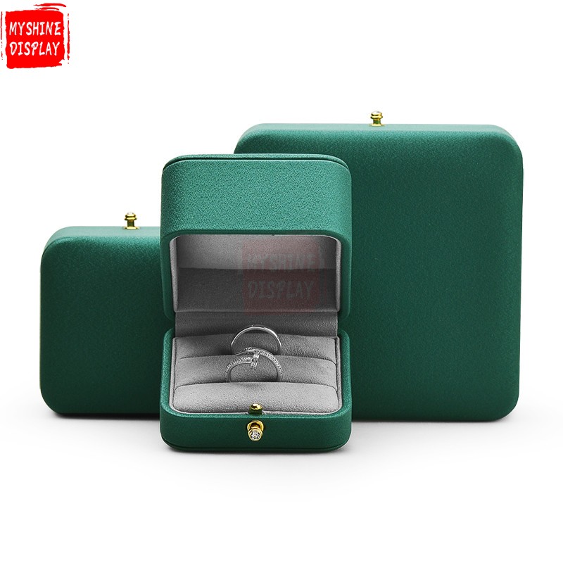 Emerald green leather jewelry packaging box with gray microfiber inside
